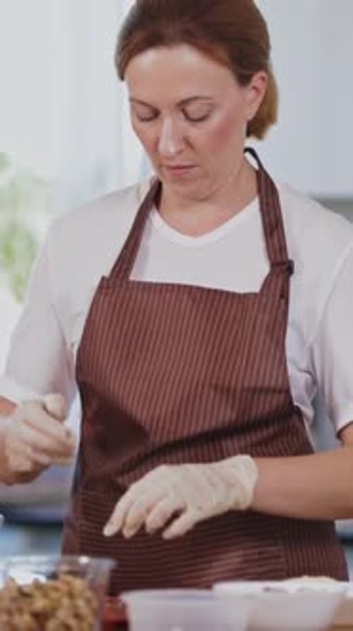 Woman Prepares Ingredients with Gloves in Kitchen