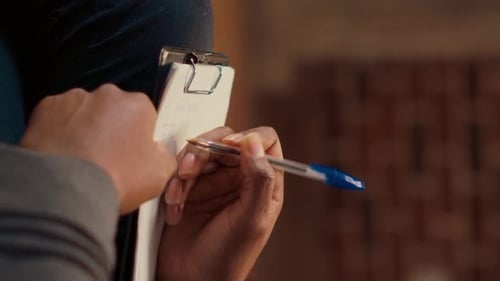 Psychothérapeute vidéo verticale prenant des notes sur des articles et écoutant l'homme