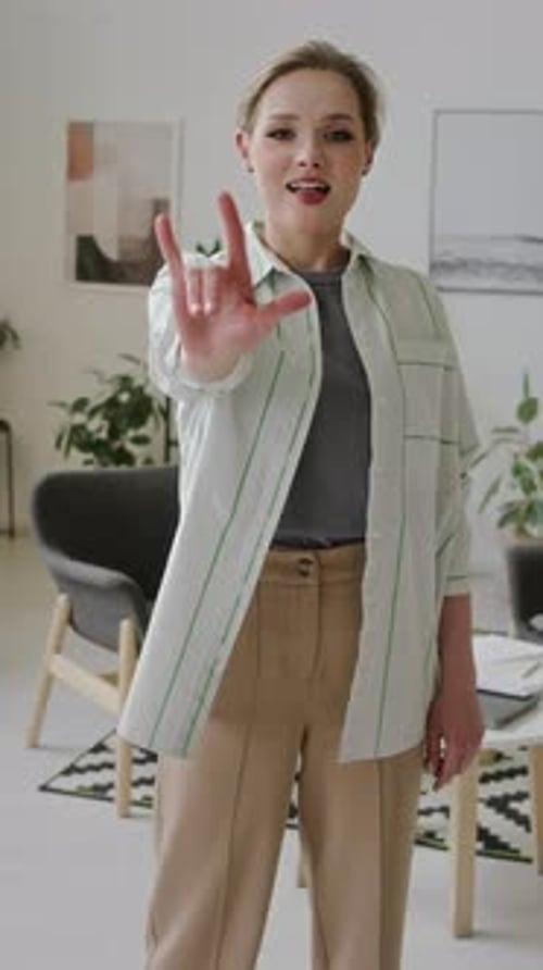 Portrait of Young Deaf Woman Saying I Love You in American Sign Language