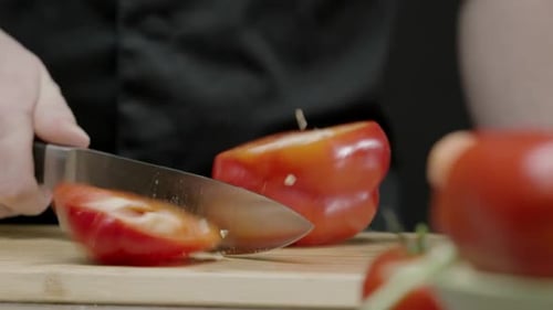 Cutting Fresh Red Bell Pepper on Board