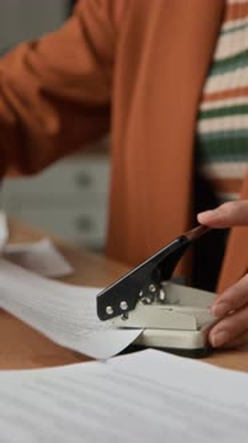 Administrative Paperwork Stapling at Office Desk