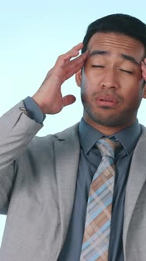 Employee, pain and man with headache in studio, wealth manager and stress for stock market or worry