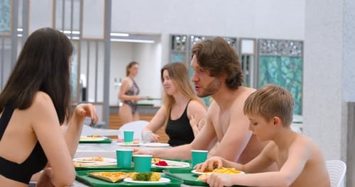 Happy Family Spending Weekend Day In Waterpark Dinner In Restaurant On Food Court Medium Portrait