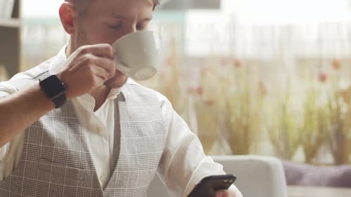 Businessman Sitting and Working in a Cafe Man Using Devices Business and Entrepreneurship Concept