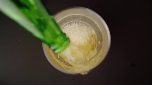 Schaumiges Bier von oben in ein Glas gießen