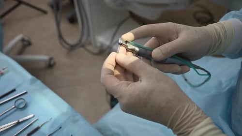 Dental Professional Preparing Instruments for Medical Procedure
