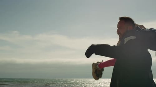 Happy Dad Carry Kid at Sea Beach. Parent Child Spinning Around Outside