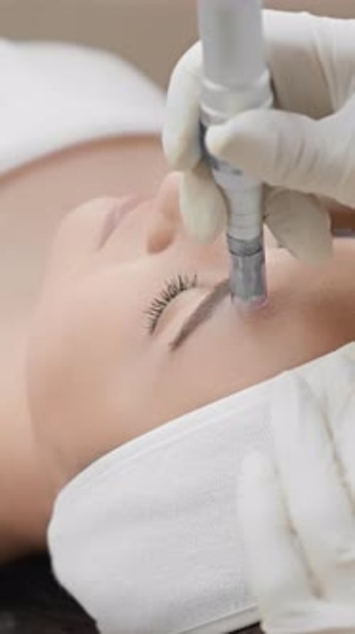 Cosmetologist Performs Cosmetic Procedure On Fair Skinned Person