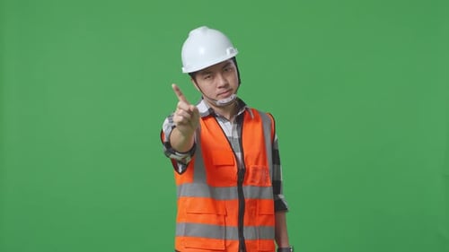 Asian Male Engineer Disapproving With No Index Finger Sign While Standing In The Green Screen