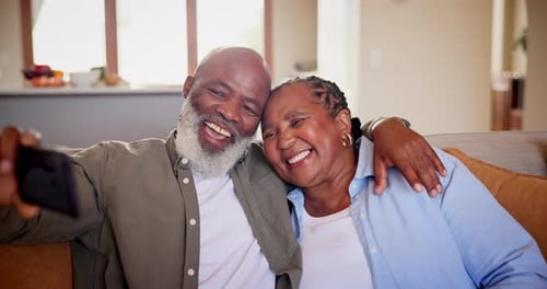 Senior Couple Taking Cheerful Selfie at Home