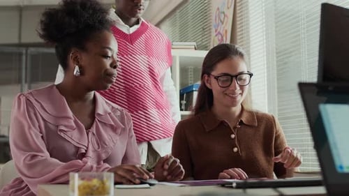 Creative Office Team Discussing Ideas while Looking at Computer Screen