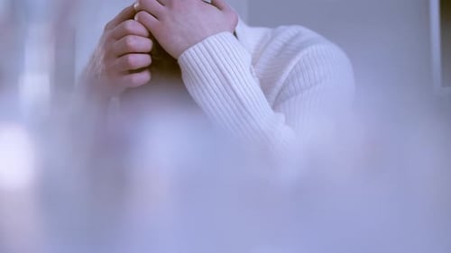 Close-up of hands of a Caucasian man holding his head in a desperate attitude. Evanescence effect