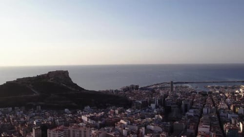 Drone slowly rising, turning, view of Santa Barbara Castle, Alicante Spain
