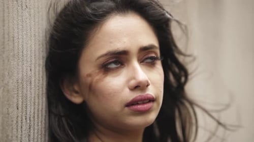 Crying young female with smudged make up sad nervous on the empty street