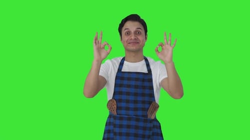 Happy Indian cook giving chef kiss Green screen