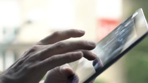 Man Browsing Internet on Tablet Standing on Terrace 20s