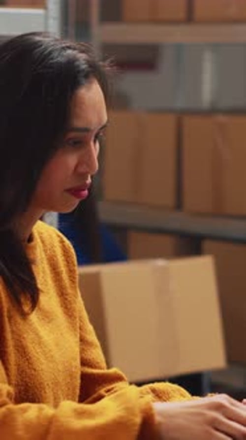 Women Collaborating on Shipping Orders in Warehouse
