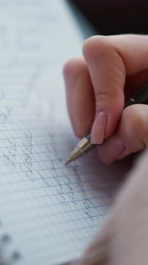 Close Up of Lady Writing in Notebook with Pen