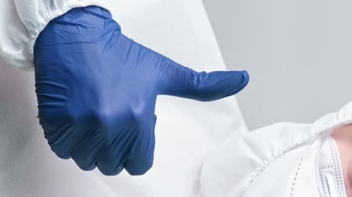 Thumbs Up Gesture with Protective Clothing