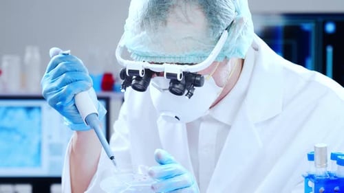 Scientist Using Pipette to Prepare Sample in Lab