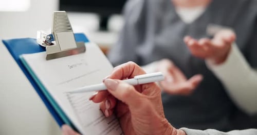 Woman Completes Medical Form at Doctor's Office