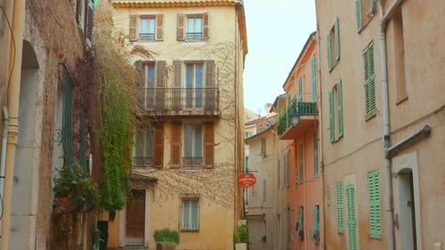 Dried Ivy On Facade Of Buildings In Old Town of Cannes In France. - wide shot