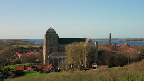 Aerial: The historical town of Veere with an old harbour and churches, on a spring day.