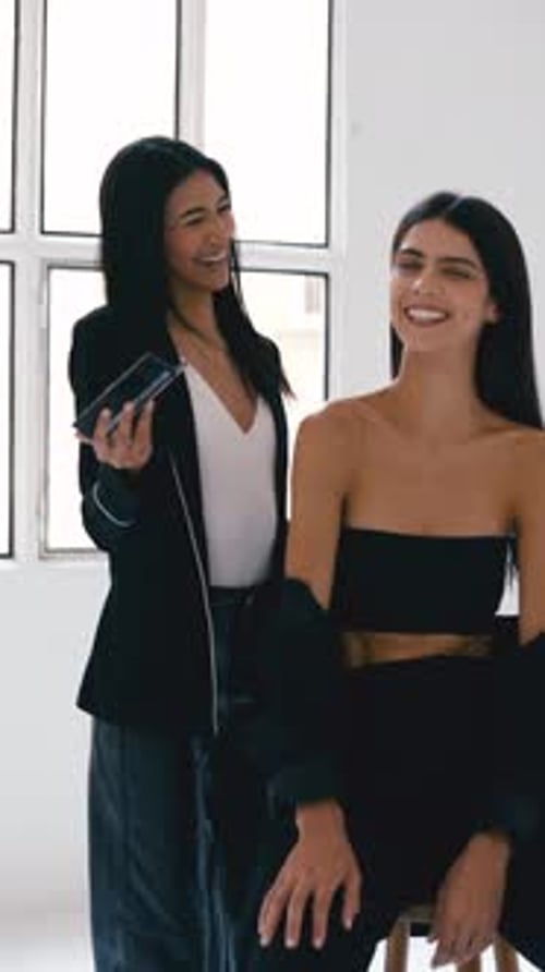 Makeup Artist Applying Makeup on Model's Face in Studio Vertical