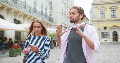 Young Caucasian Male and Female Students Walking and Talking to Each Other on City Street Handsome