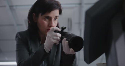 Close Up of Female Criminalist Taking Photos of Evidence at Crime Scene with Camera