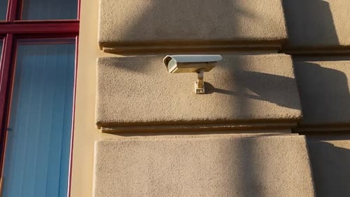 Security Large CCTV Camera Pointed to the Left on a Wall Outdoors