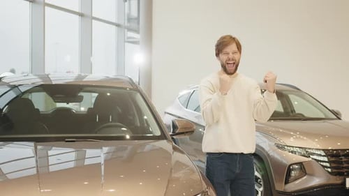 Man Celebrates a New Car Purchase