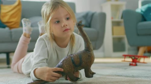 Child Plays with Dinosaur Toy on Living Room Floor