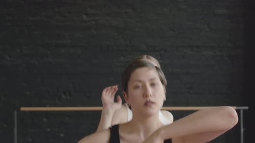 Young Adult Woman Stretching in Dance Studio