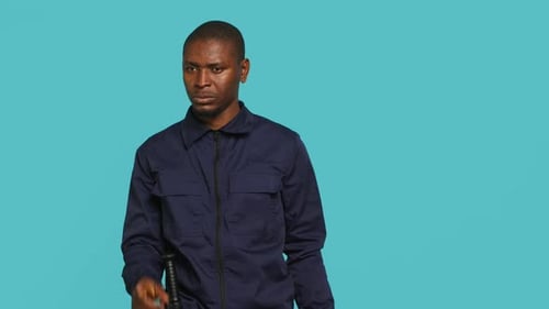 Man in Blue Uniform Saying Stop