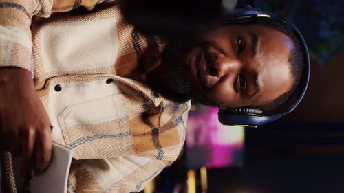 Young Man Chatting to Camera Wearing Headphones