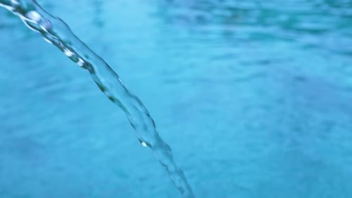 Water Flowing Into Refreshing Blue Swimming Pool