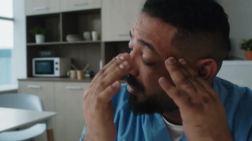 Tired Doctor Falling Asleep in Break Room during Workday in Hospital