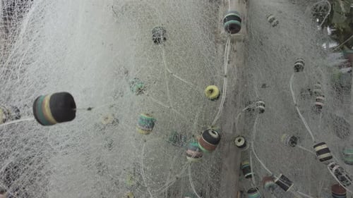 A stationary closeup shot of a fishing net used by fishermen to catch fish from the sea.