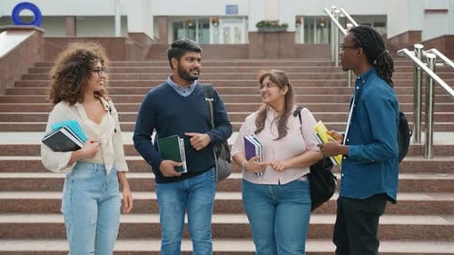 Diverse Group of University Students High Fiving on Campus Steps