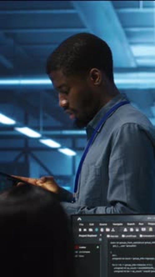 Worker Using Tablet in Tech Workplace