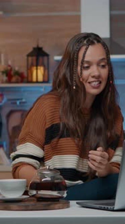 Vertical Video Festive Woman Talking on Video Call Using Laptop