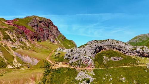 Beautiful picturesque mountains with touristic trails crossing the slopes. Blue sky at backdrop.