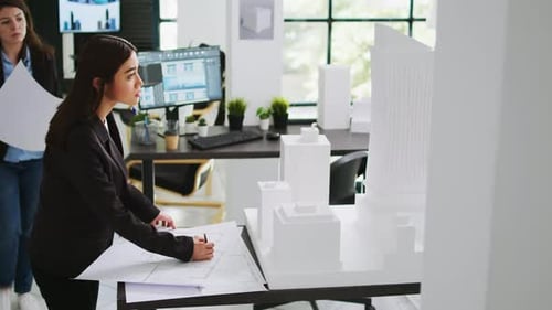Architects Team Studying 3d Printed Building Model in Office