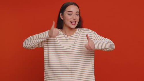 Enthusiastic Young Woman Giving Double Thumbs Up