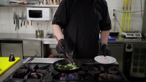 Chef Stir Frying Vegetables in a Restaurant Kitchen