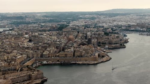 Drone shot circling the skyline of Valletta city, cloudy evening on Malta island