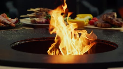 Bright fire flames burning in bbq grill outdoors getting hot for cooking food