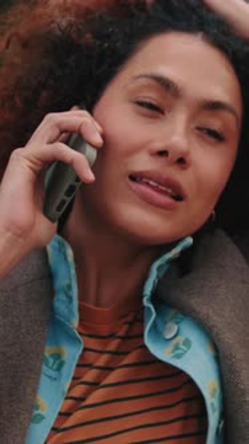 Vertical video, Young Woman Talking on Phone Outdoors