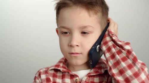 Boy Talking on Mobile Phone in Close Up
